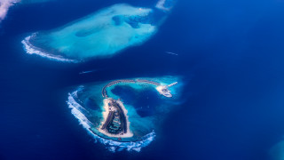 Aerial island plane landing blue - chris labrooy free wallpaper