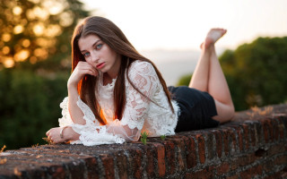 Woman brick wall crossed legs - a brick wall free wallpaper