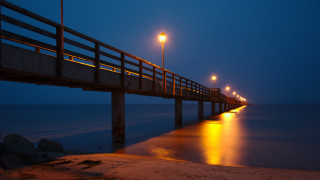 Pier lights night beach water - a body of water below free wallpaper