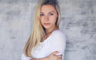 Blonde woman crossed arms concrete - free portrait wallpaper