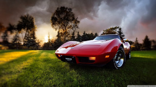 Red sports car field cloudy 2 - a field under a cloudy sky free wallpaper