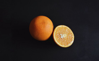 Two oranges halved minimalist stilllife - one cut free wallpaper
