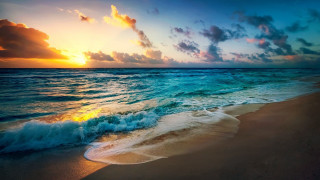 Beach waves sunset ocean lighthouse - the sand and a sunset in the background free wallpaper