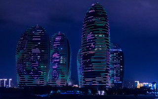 Futuristic cityscape night skyline reflection - a boat in the foreground free wallpaper