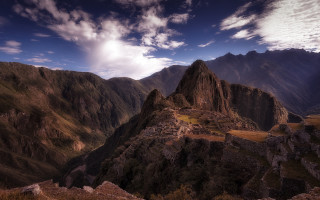 Mountain cliffs cloudy sky ocean - a few building free wallpaper