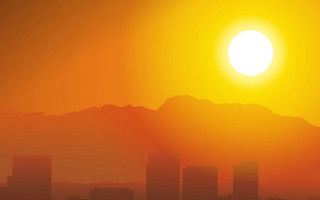 City skyline mountains sunset silhouette - a bright sun in the background free wallpaper