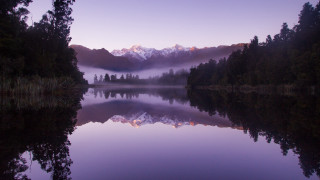 Lake mountains forest sunset blooming - a foggy sky in the background free wallpaper
