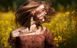 Woman field yellow flowers blowing - a woman in a field free wallpaper