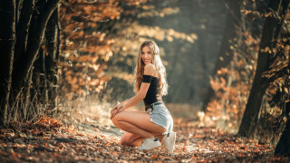 Woman kneeling forest autumn fire - the ground and trees free wallpaper