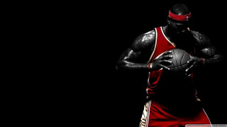 Man holding basketball red uniform - rim free wallpaper