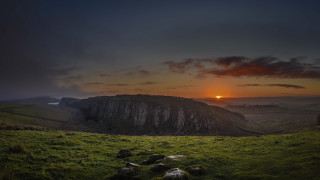 Sunset grassy field mountain cloudy - widescreen free wallpaper