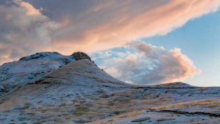 Mountain peak cloudy sky ocean - a few rock below free wallpaper