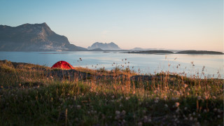 Red tent grassy hill lake - a mountain range in the distance free wallpaper