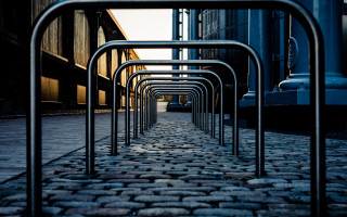 Metal bars cobblestone street clocktower - constructivism free wallpaper