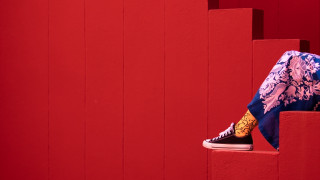 Person sitting red wall sneakers - a pair of sneakers free wallpaper