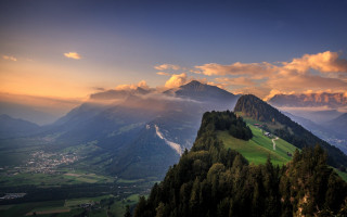 Mountain range valley clouds trees - a valley below free wallpaper