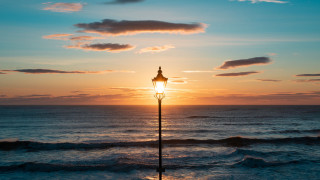 Ocean sunset lighthouse waves reflection - orange sky free wallpaper