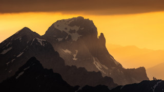 Mountain peak yellow sky clouds - a yellow sky in the background free wallpaper