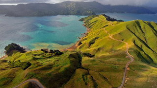 Scenic green mountain lake road 2 - a mountain range in the background free wallpaper