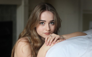 Woman laying bed ring portrait - her finger free wallpaper