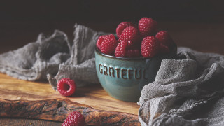 Raspberries bowl wooden table cloth - a wooden table free wallpaper