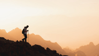 Mountain hiker sunset sky clouds - a backpack free wallpaper