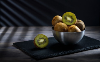 Kiwi bowl black cloth table - hyperrealism free wallpaper
