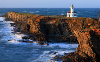 Lighthouse cliff ocean waves sunset - wave free wallpaper