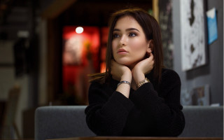 Woman sitting serious brown hair - her chin free wallpaper