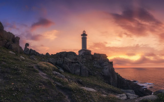 Lighthouse rocky cliff sunset mystical - a rocky cliff free wallpaper