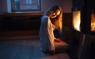 Woman sitting fireplace candle art - warm free wallpaper