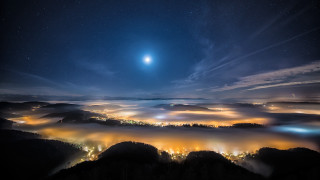 City night moon clouds aurora - a view of a city free wallpaper