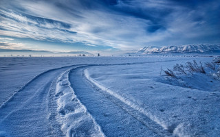 Snow tracks mountain cloudy sky - a cloudy sky free wallpaper