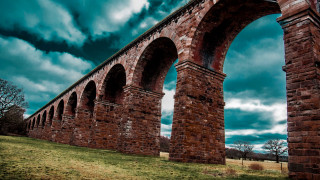Large bridge arch tilt shift - a dark sky in the background free wallpaper