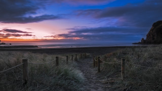 Beach sunset lighthouse cloudy sky - a path free wallpaper