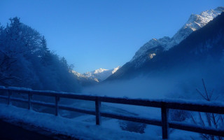 Snowy mountain range fence blue - in the foreground free wallpaper