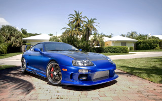 Blue sports car brick driveway - fine art free wallpaper