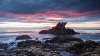 Rocky beach sunset pink sky 4 - a small island in the middle of it free wallpaper