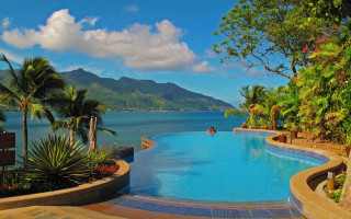 Large pool ocean mountains palm - a view of the ocean and mountains free wallpaper