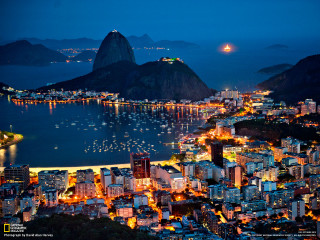 City night mountain water boats - a mountain in the background and a body of water free wallpaper