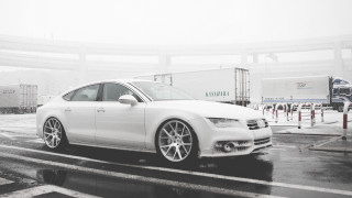 White car rain parking lot - a building in the background free wallpaper