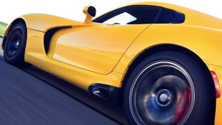 Yellow sports car blurry wheels - a yellow sports car free wallpaper