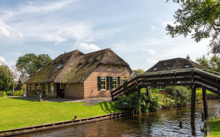Thatched roof house river bridge - a bridge over free wallpaper