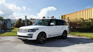 White range rover parked yellow - a yellow wall behind free wallpaper