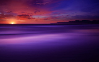 Sunset mountain water purple sky - a sunset over a body of water free wallpaper