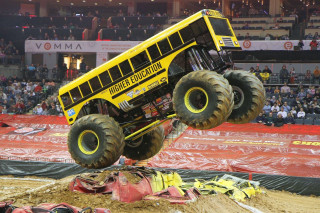 Monster truck mid air dirt - a monster truck free wallpaper