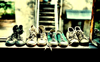 Shoes wooden table doorway staircase - a staircase in the background free wallpaper