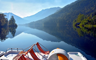 Lake mountains trees boat sunbeam - a sunbeam in the distance free wallpaper