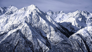 Mountain range snowy cloudy sky - a blue sky background free wallpaper