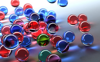 Colorful glass balls table top - a white surface free wallpaper